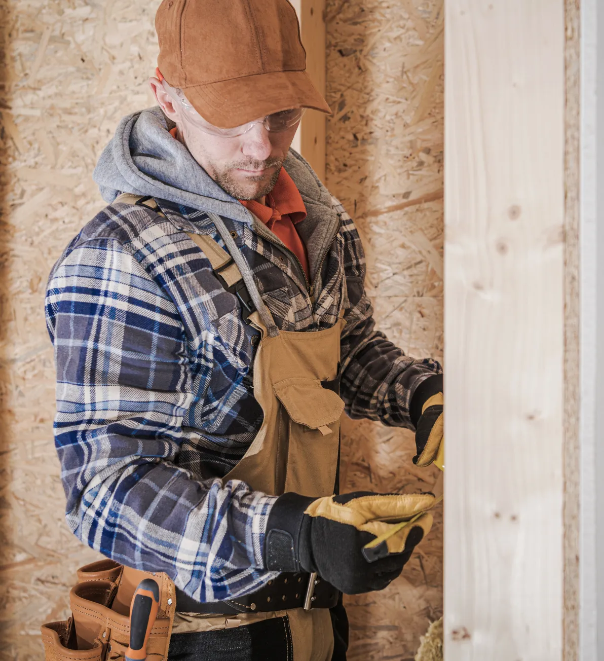 Carpentry contractor in Los Angeles measuring wood framing for residential construction