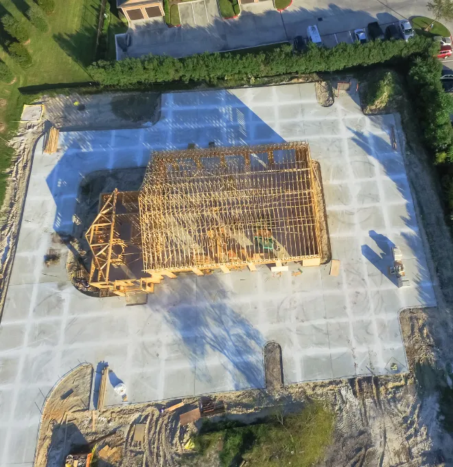 Aerial view of custom home building in Los Angeles with wood framing for new construction