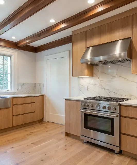 Kitchen remodeling project in Los Angeles with modern wood cabinets, stainless steel appliances, marble backsplash, and hardwood flooring